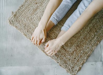 Close-up on hands and feet showing precise positioning during an exercise.