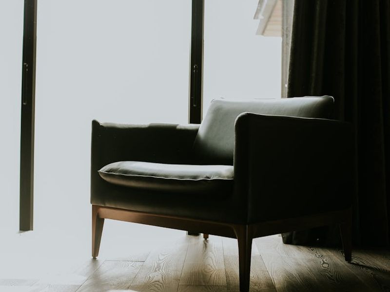 Wide shot of a person exercising in a spacious, sunlit room.
